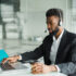 Businessman using laptop and headset.